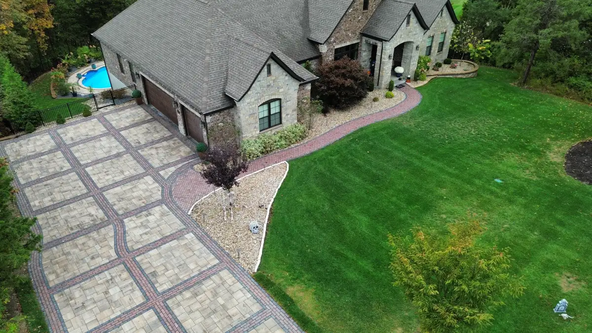 Wide-angle view of custom paver driveway with brick accent borders