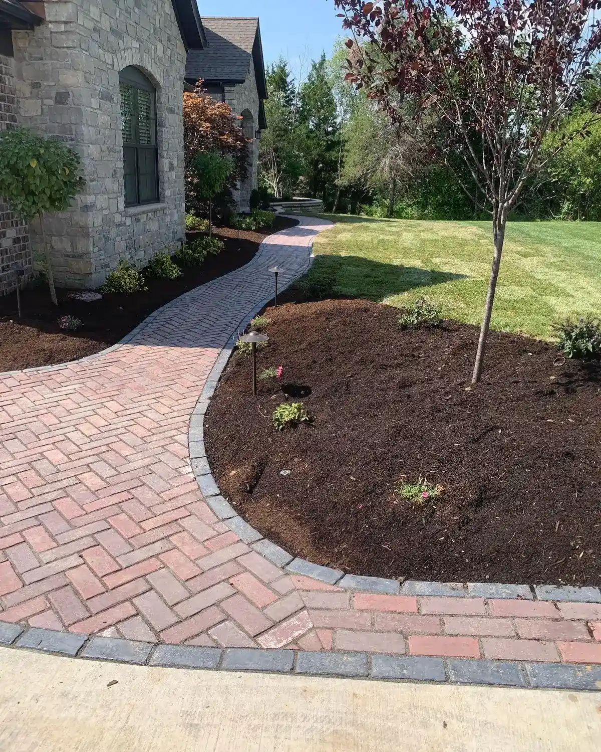 Custom herringbone brick driveway installed by Green Operations