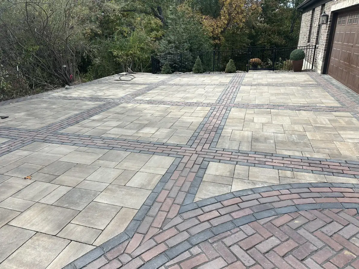 Paver driveway detail showing brick accent band pattern by Green Operations