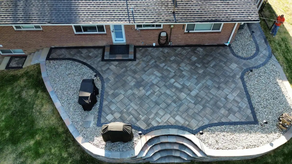 Aerial view of custom paver patio with curved steps and accent borders