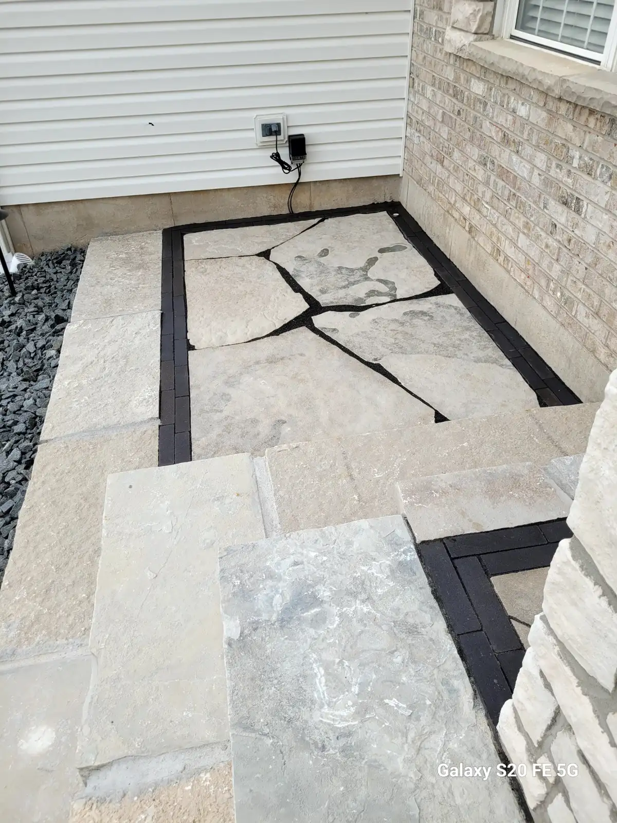 Flagstone patio with dark borders built by Green Operations