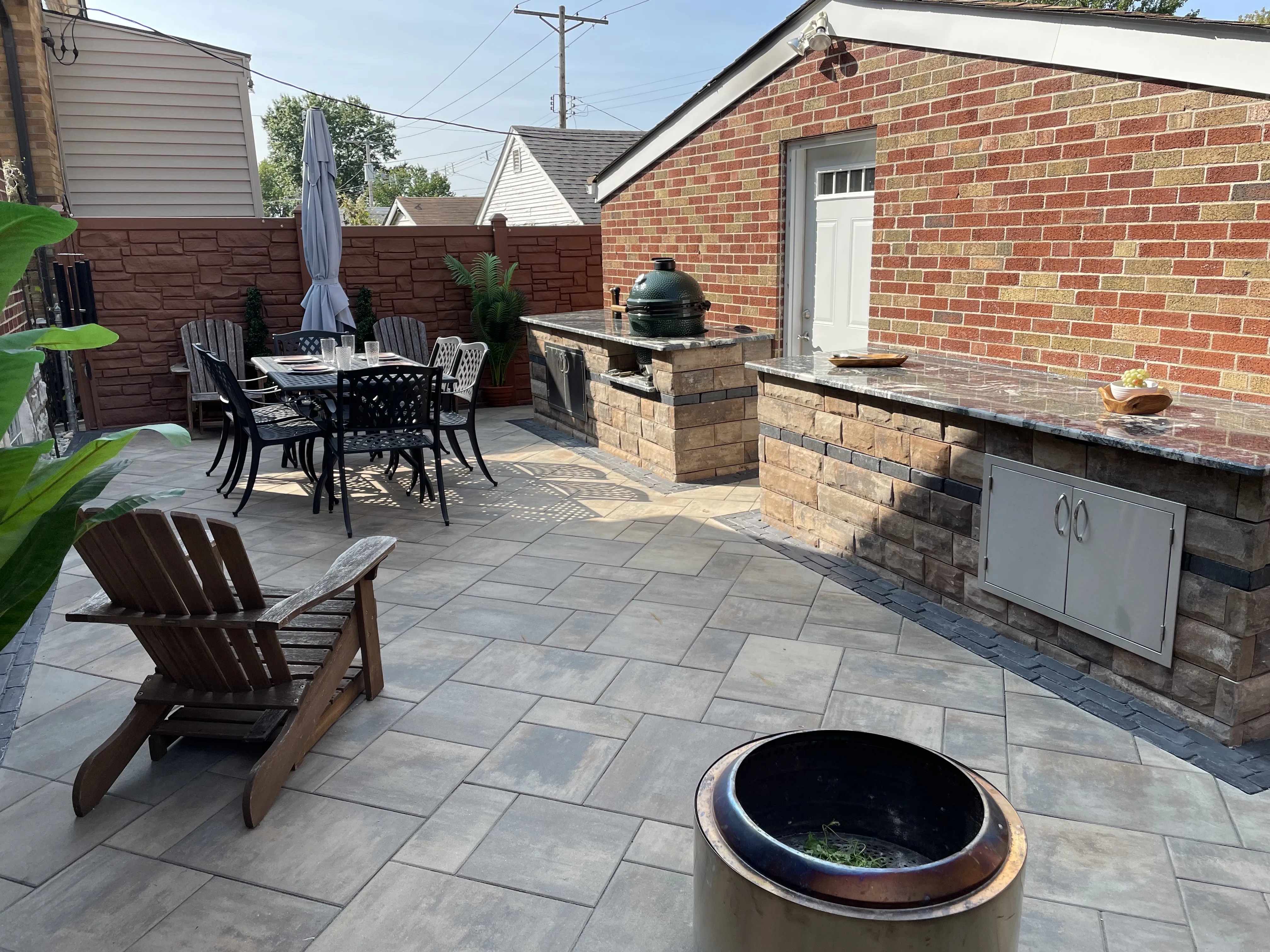 Outdoor dining patio with paver surface by Green Operations