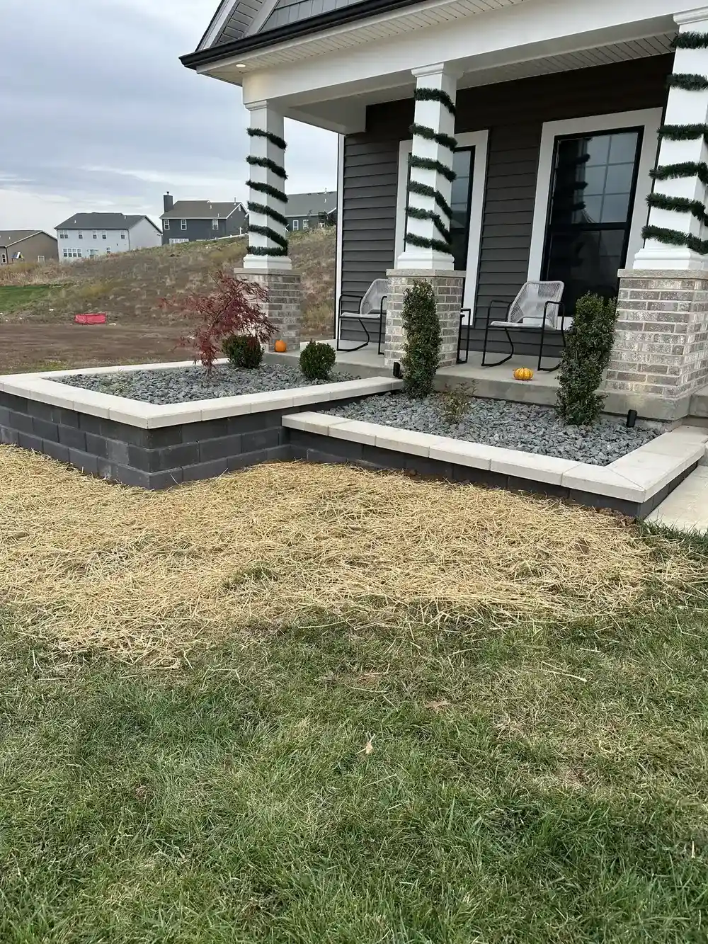 New construction landscaping with rock beds and shrubs in St. Louis
