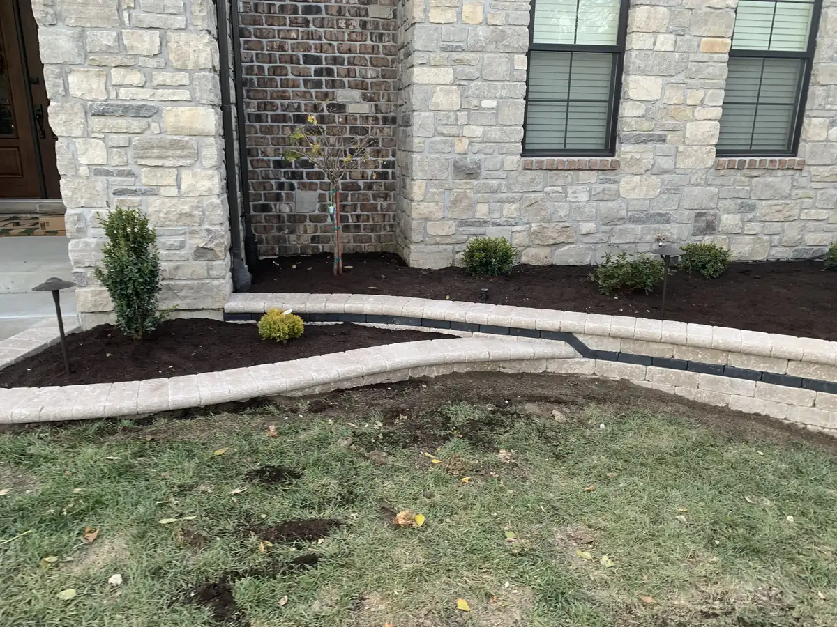 Natural stone retaining wall with planting beds