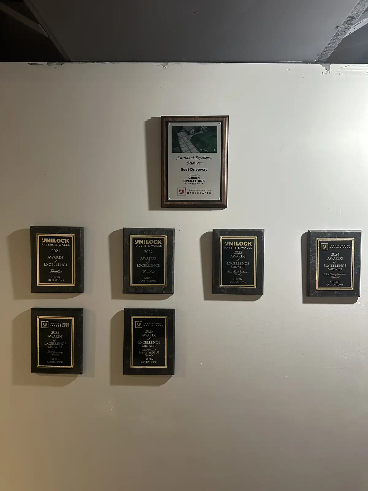 Green Operations awards wall featuring Unilock Authorized Contractor certification
