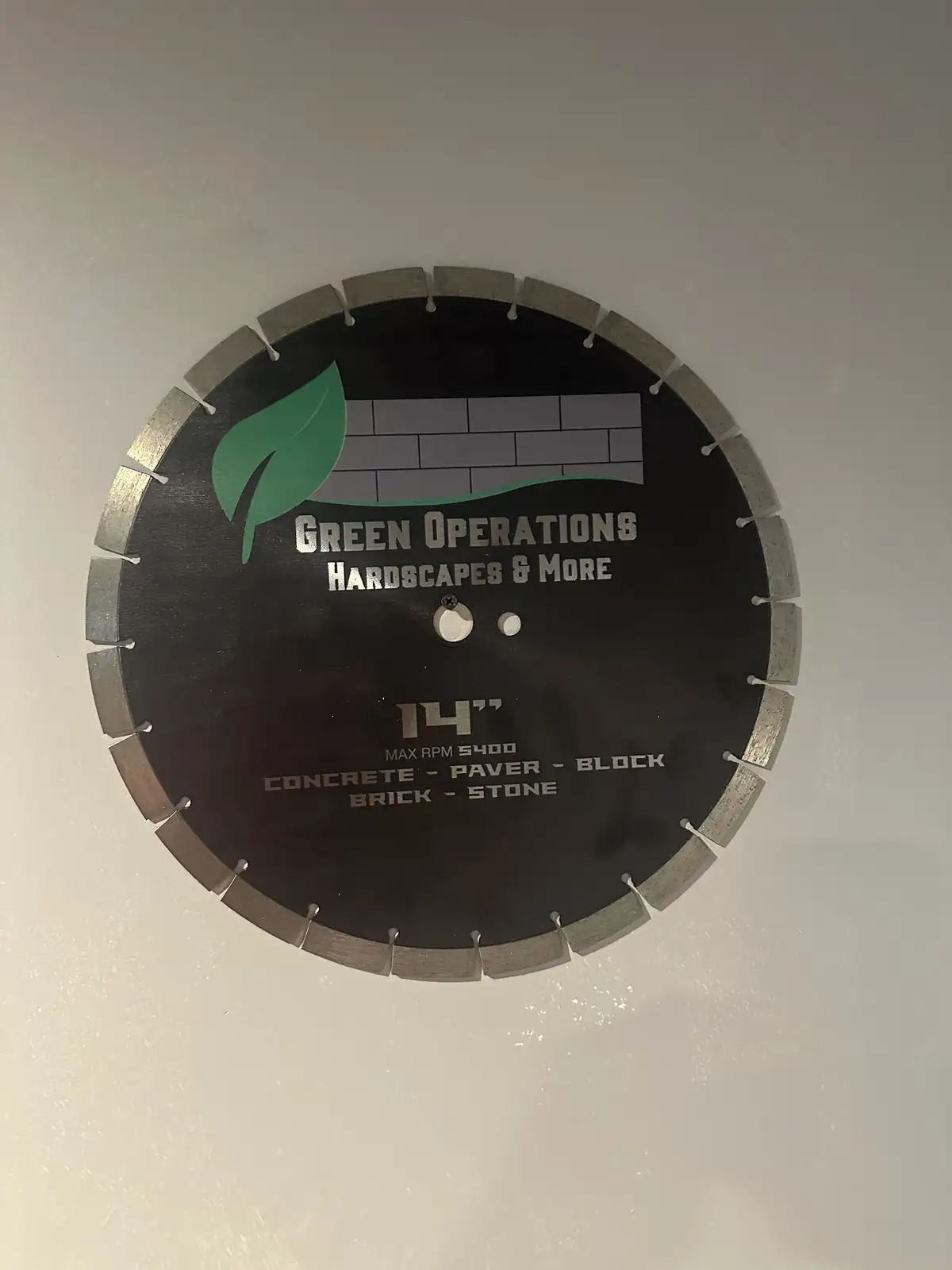 Green Operations branded diamond blade saw for precision paver cutting